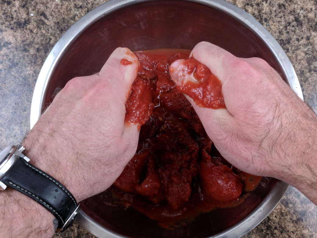 tomato sauce crushing tomatoes by hand