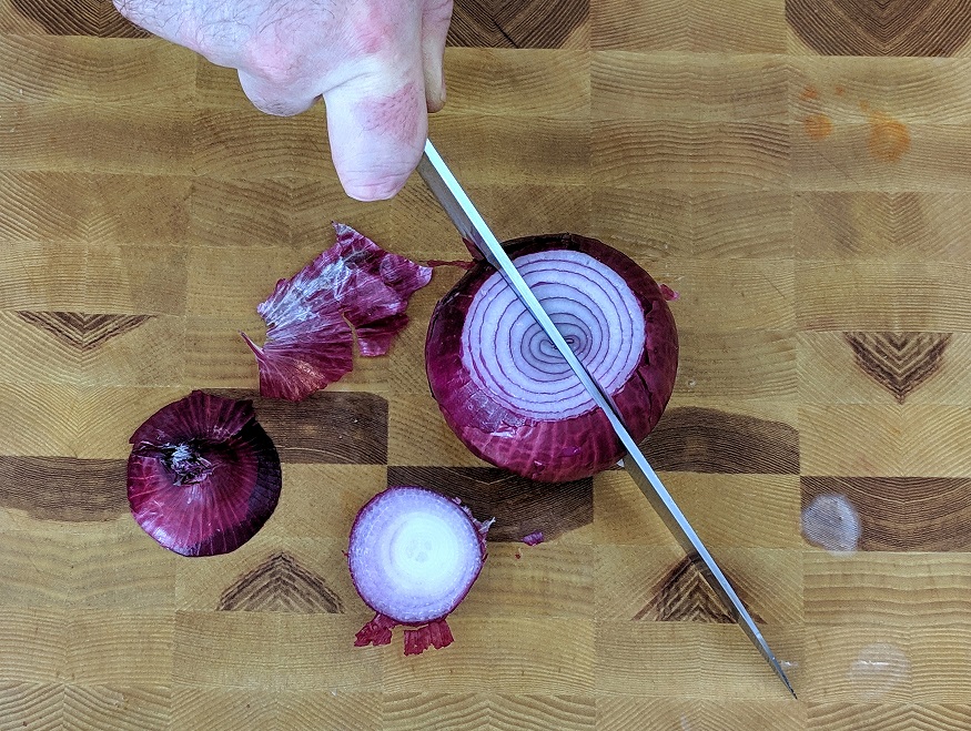 cutting a red onion in half
